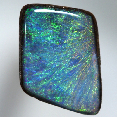 SOLID BOULDER OPAL Bright orange and green sparkles over blue